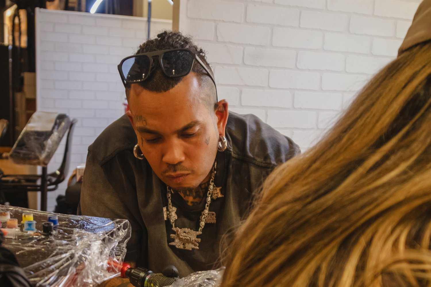 Founder Ron Pichardo tattooing a client at The Station